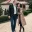 A couple walking together outdoors.