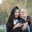 A couple smiling together in a park.