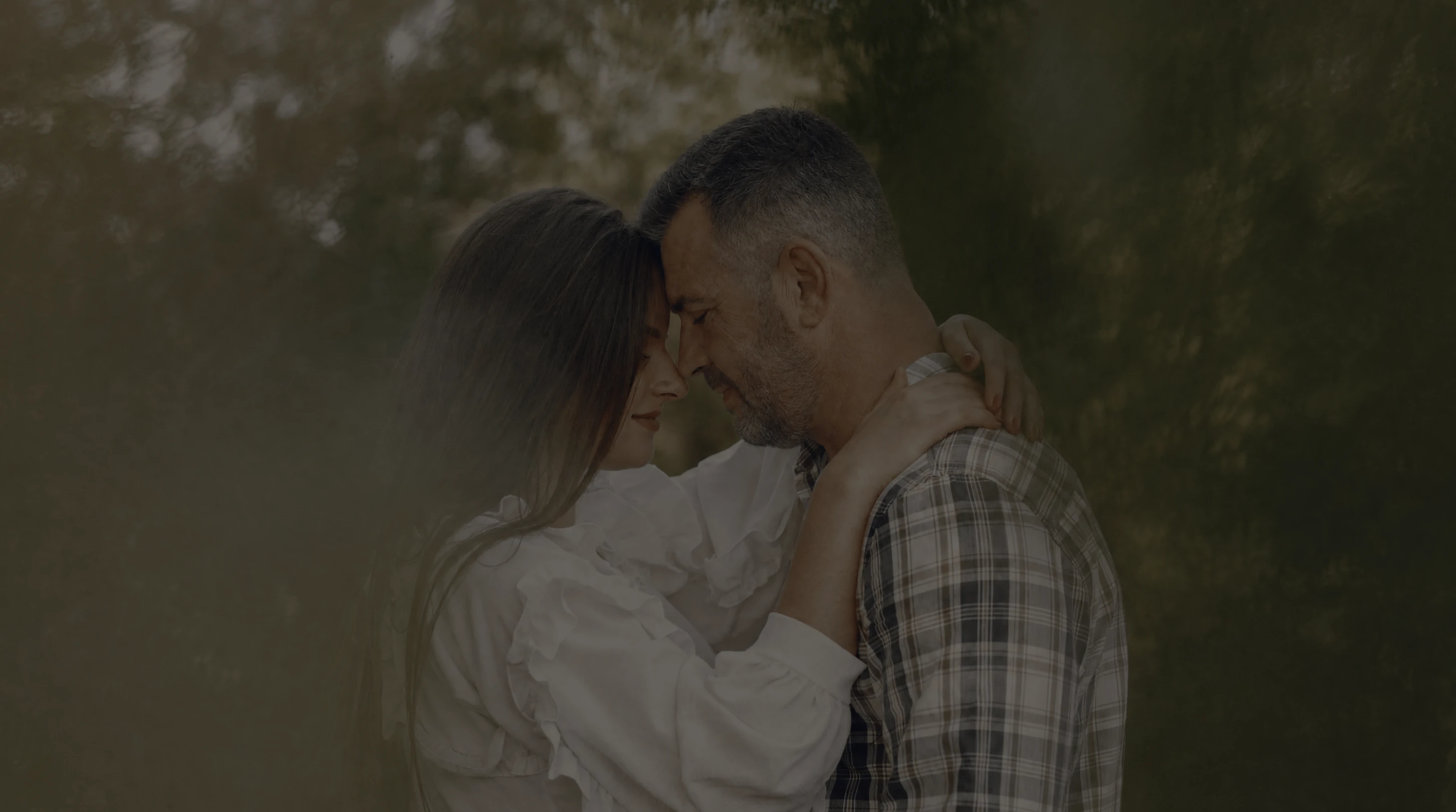 A couple embracing outdoors.
