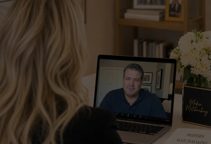A matchmaker speaking with a client by video call.